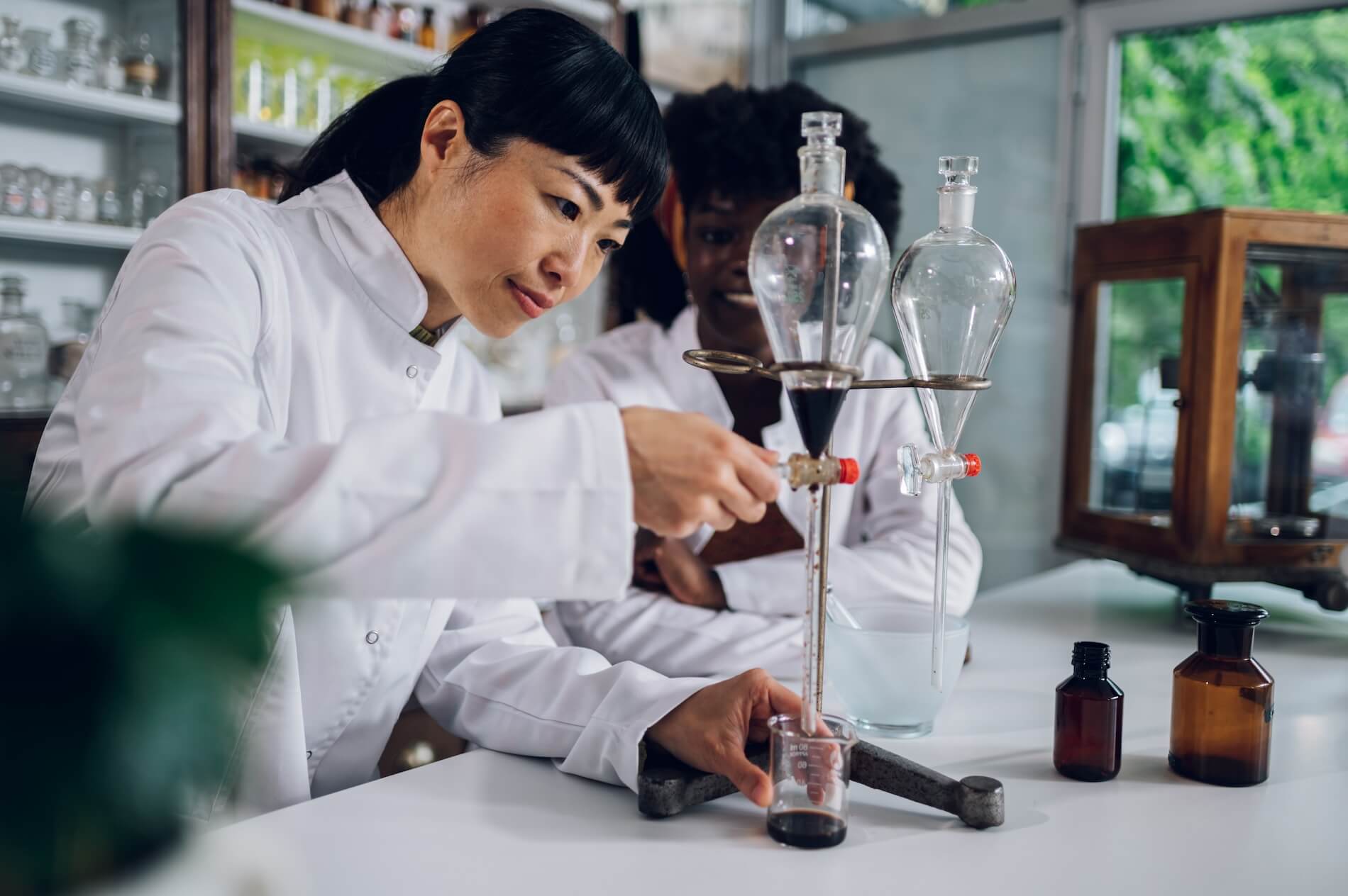 a-japanese-pharmacist-is-using-a-funnel-with-her-a-2023-11-27-05-32-05-utc