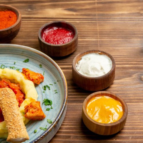 front-view-tasty-meat-slices-with-mushed-potatoes-seasonings-brown-desk-dish-meat-meal-potato-bread-food