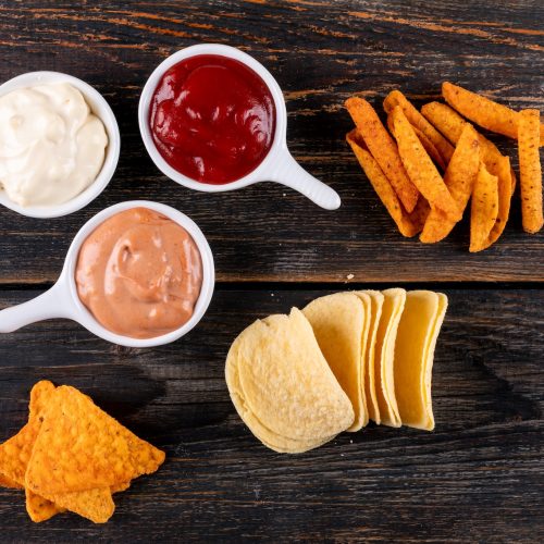 top-view-chips-with-sauses-bowls-brown-wooden top-view-chips-with-sauses-bowls-brown-wooden